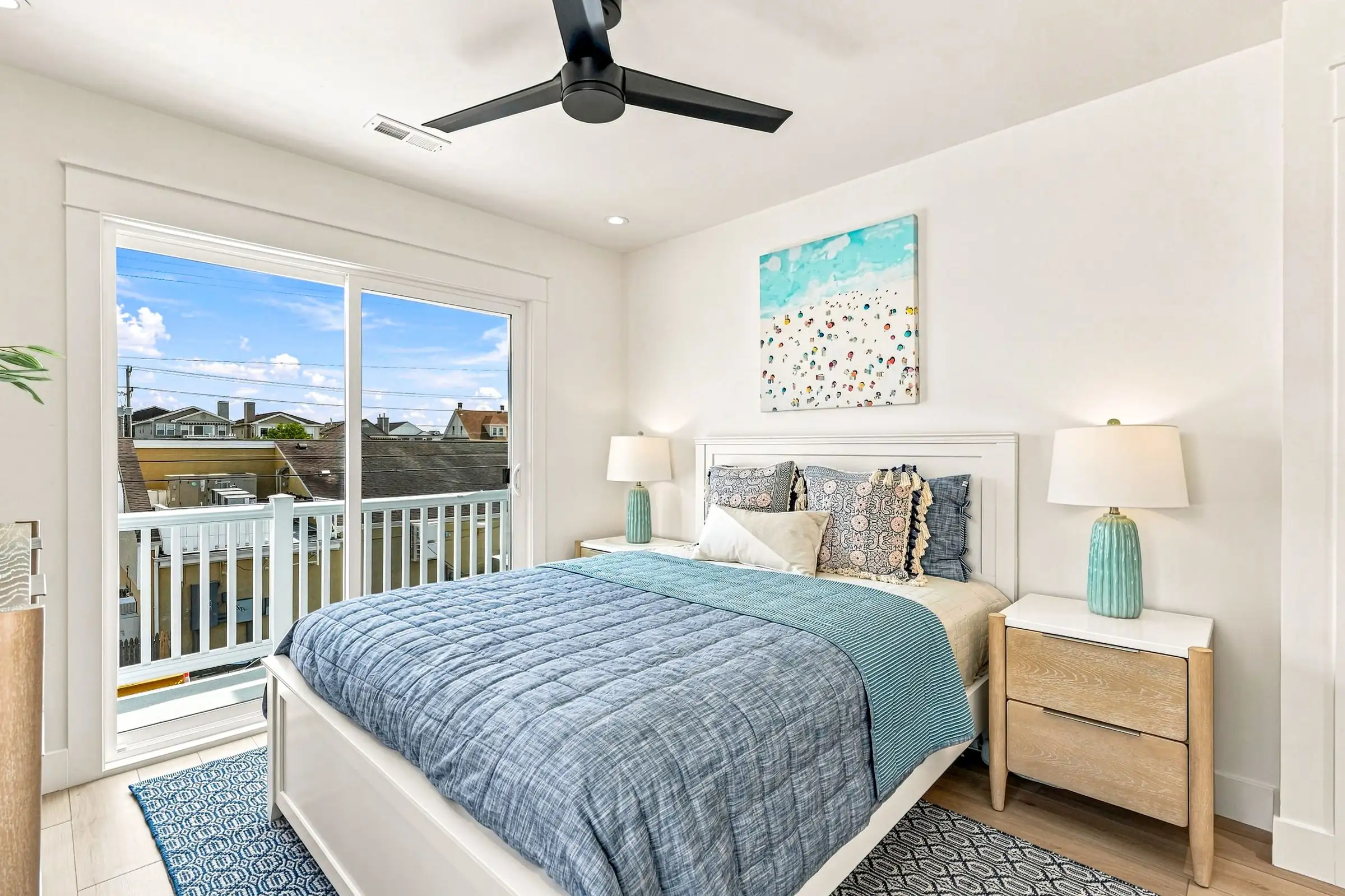 Second bedroom with a queen bed and sliding door to a private balcony
