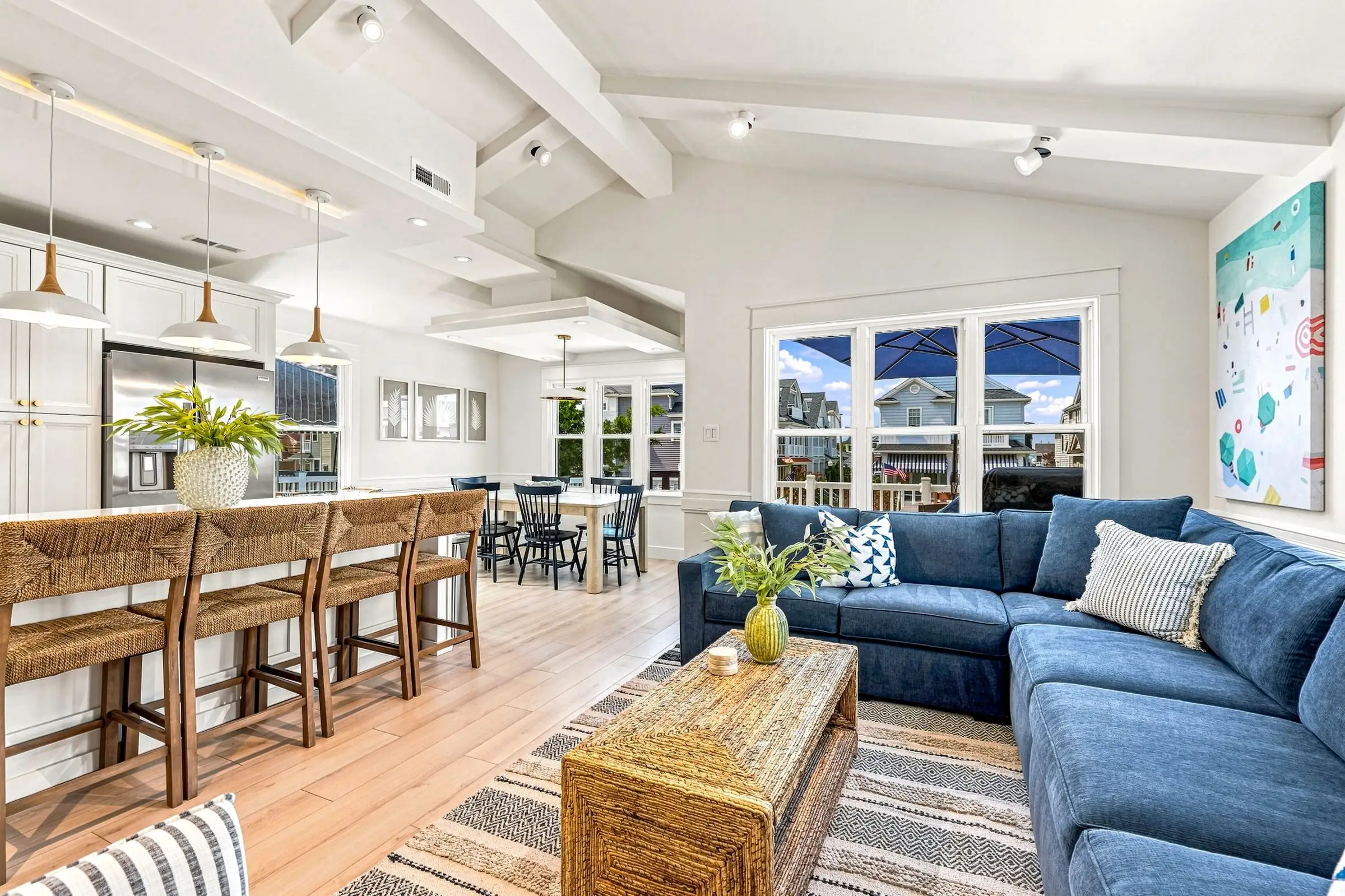 Open-plan living room and kitchen under a vaulted beamed ceiling